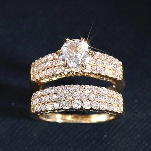 Macro shot of 18K gold ring set with six-prong zircon and pave diamond wedding bands