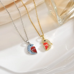 Detailed macro view of 18k gold plated dolphin heart necklaces with rhinestone inlays