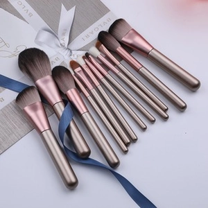 Detail view of 8pcs mini makeup brush set with rose gold handles and soft brown bristles