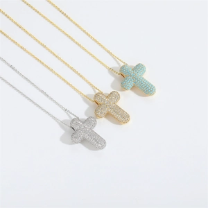 Detailed view of elegant cross pendants in gold and silver with zircon and turquoise beads
