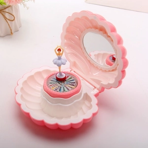 Pink shell music box detail with ballet dancer, makeup mirror and pleasant music engraving