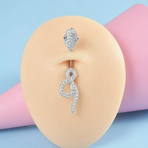 Detail of silver belly ring with zircon stones shown on a silicone body model
