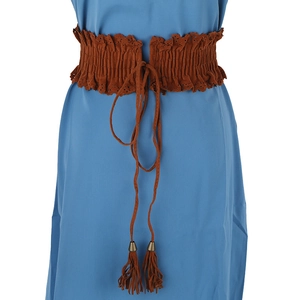 Detail of brown faux suede wide corset belt featuring hollow lace edges and tassel ties