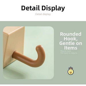 Detail of adhesive wall hook with rounded ball end in brown and beige plastic finish