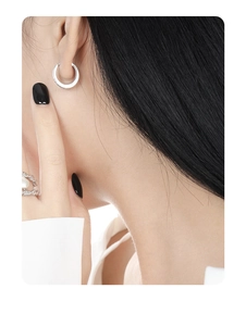 Side view of model wearing S925 sterling silver hoop earrings with micro-pave crystals