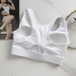 Detailed flat lay of white zip-front sports bra with breathable knit texture and racerback