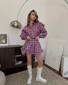 Detail of pink plaid two-piece set featuring puff sleeve shirt and ruffled mini skirt