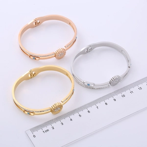 Evil eye stainless steel spring bangle with diamonds in rose gold and silver