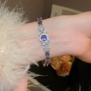Detailed close-up of a zircon flower bracelet with purple stones on a silver base