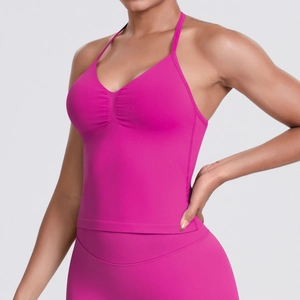 Close-up of bright pink seamless knit sports top with halter neck and ruching detail