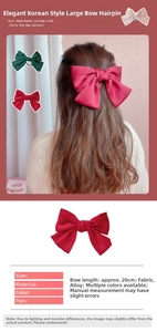 Detail showing oversized 20cm satin bow hair clips in red, green and pink colors