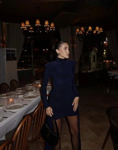 Detail of navy long sleeve mini dress with padded shoulders and ruched waist detail