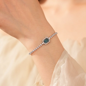 Macro shot of an adjustable silver bracelet featuring a radiant blue rectangular gemstone