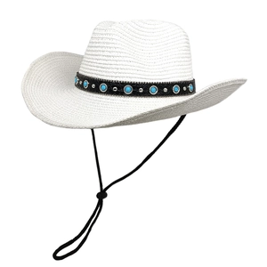 Detail of white straw cowboy hat with turquoise studs and adjustable chin strap
