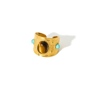 Detail of vintage 18k gold plated cuff with tiger eye stone and turquoise accents