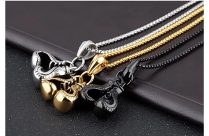 Detailed view of boxing glove pendants in silver, gold, and black finishes on chains