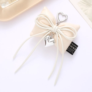 Beige leather bow keychain with silver heart pendant and metal clasp for bags and phones
