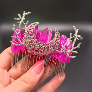 Detailed shot of pink crystal hair comb with silver moon and antler branch design