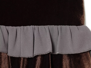 Detailed macro view of brown velvet and grey woven fabric ruffles on a mini skirt