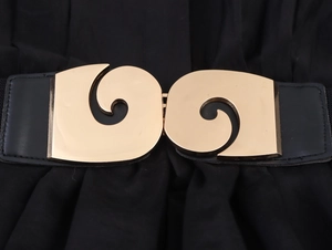 Detailed view of wide black waist belt featuring a large interlocking gold metal buckle