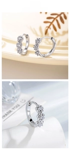 Macro shot of silver zircon flower hoop earrings with high-polish finish and floral details