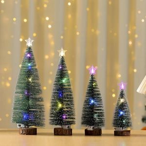Miniature lit cedar Christmas trees with snow effect and solid wood bases