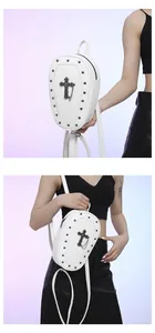 Detailed view of white coffin bag with silver rivets and gothic cross charm