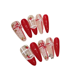 Handmade red cat-eye press-on nails with strawberry, snowflake, and bow designs