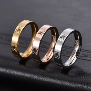 Three minimalist stainless steel star rings in gold, rose gold and silver finishes