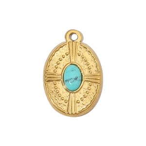 Macro detail of oval turquoise stone set in a vintage style gold stainless steel pendant