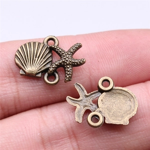 Macro shot of bronze starfish and seashell connectors for DIY jewelry making and crafts