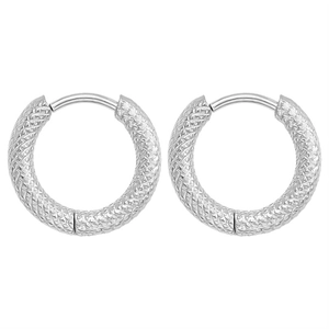 Detail shot of silver hoop earrings featuring a sophisticated diamond-cut textured pattern