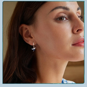 Close-up of elegant hummingbird earrings in 925 sterling silver worn by a model
