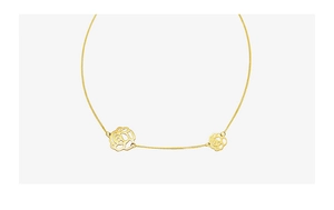 Detail of 18K gold-plated necklace featuring dual openwork black rose flower pendants