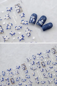 Detail of blue and white ink style floral nail stickers with Chinese flower designs