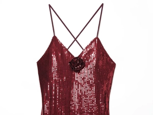 Detail of wine red sequin dress featuring 3D floral accent and fine shoulder straps