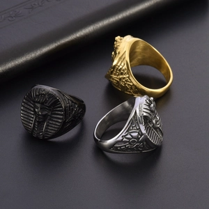 Detail of vintage Egyptian Pharaoh rings in black, silver, and gold stainless steel