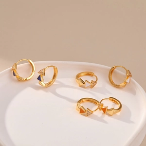 Macro shot of geometric enamel hoop earrings with colorful glaze and cubic zirconia stones