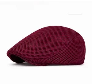 Detail of wine red mesh newsboy cap showing breathable fabric and fine stitching