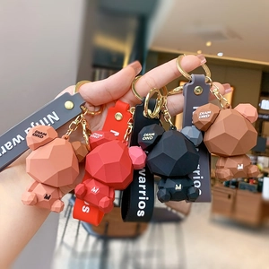 Geometric faceted bear keychain with metal ring and decorative strap in four matte colors