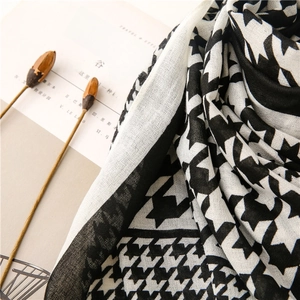 Detail of black and white houndstooth scarf with lightweight breathable woven texture