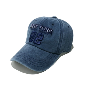 Close-up of New York 92 3D embroidery on navy washed cotton baseball cap with seam details