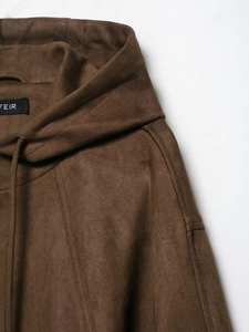 Close-up of brown suede hooded bomber jacket showing fabric texture and FEIR logo