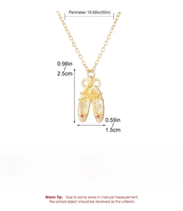 Macro detail of golden ballet slipper pendant with pink rhinestones and dimensions