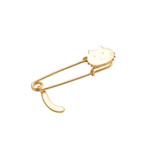 Detail of cute white enamel cat brooch featuring a gold safety pin and dangling tail charm