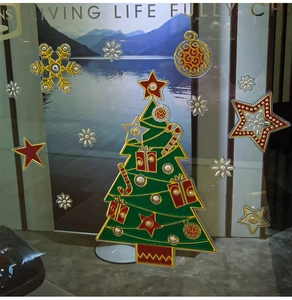 Close-up of sparkling Christmas tree window stickers with gift boxes and snowflakes
