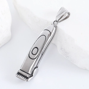 Detailed close-up of a silver stainless steel barber clipper pendant on white stones