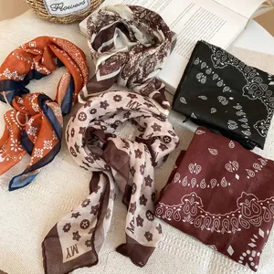 Retro silk scarf necklace set with mixed vintage prints on a soft textured background