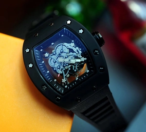 Detailed close-up of a black skeleton mechanical watch with a tonneau-shaped case design