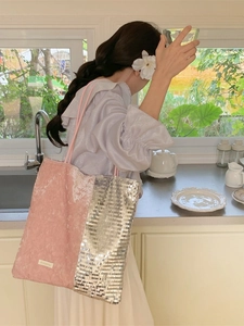 Pink velvet and silver sequin large tote bag with brand label worn by model